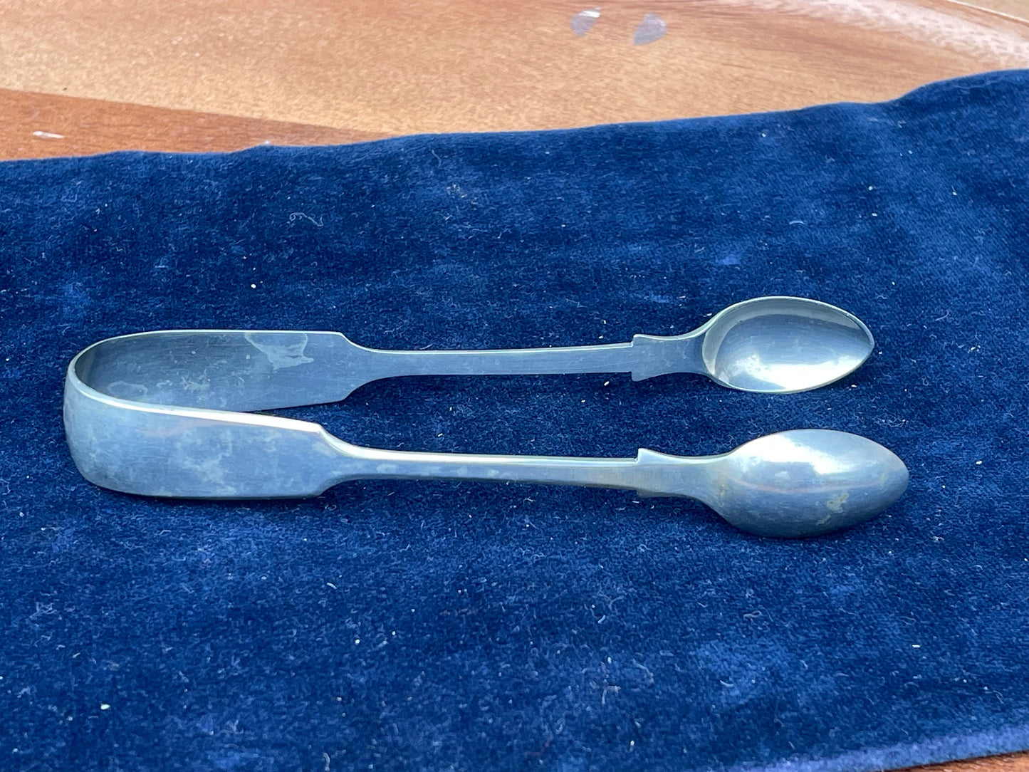 A  pair of silver plate sugar tongs by Pinder Bros 11.5cm long