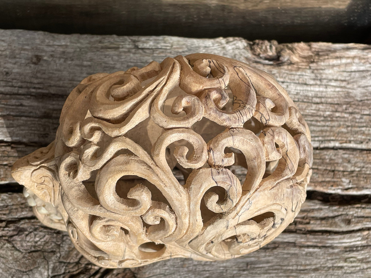 An intricately hand carved Folk Art Skull  sculpture from Tamarind wood and buffalo jaw 17cm tall