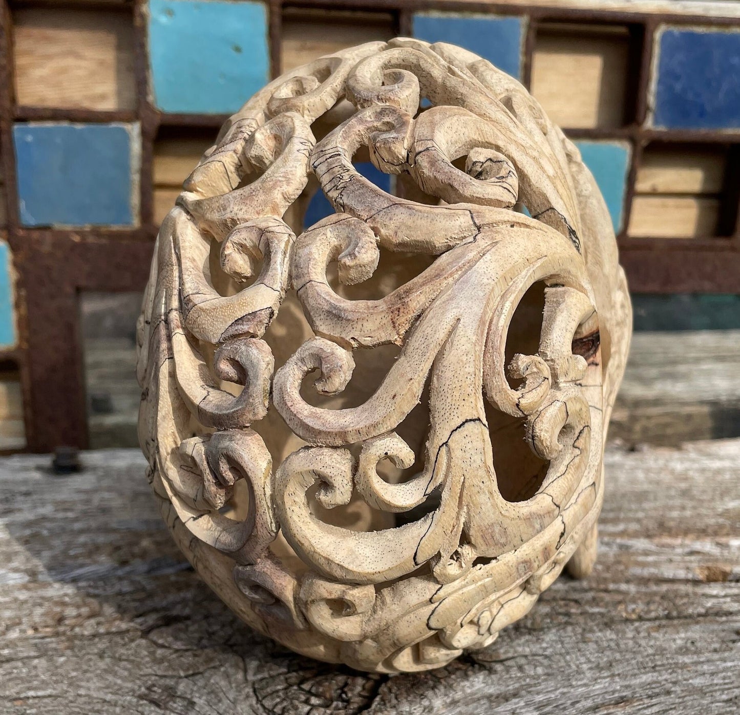 An intricately hand carved Folk Art Skull  sculpture from Tamarind wood and buffalo jaw 17cm tall