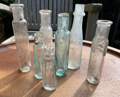 Seven Antique and vintage glass bottles tallest 15cm