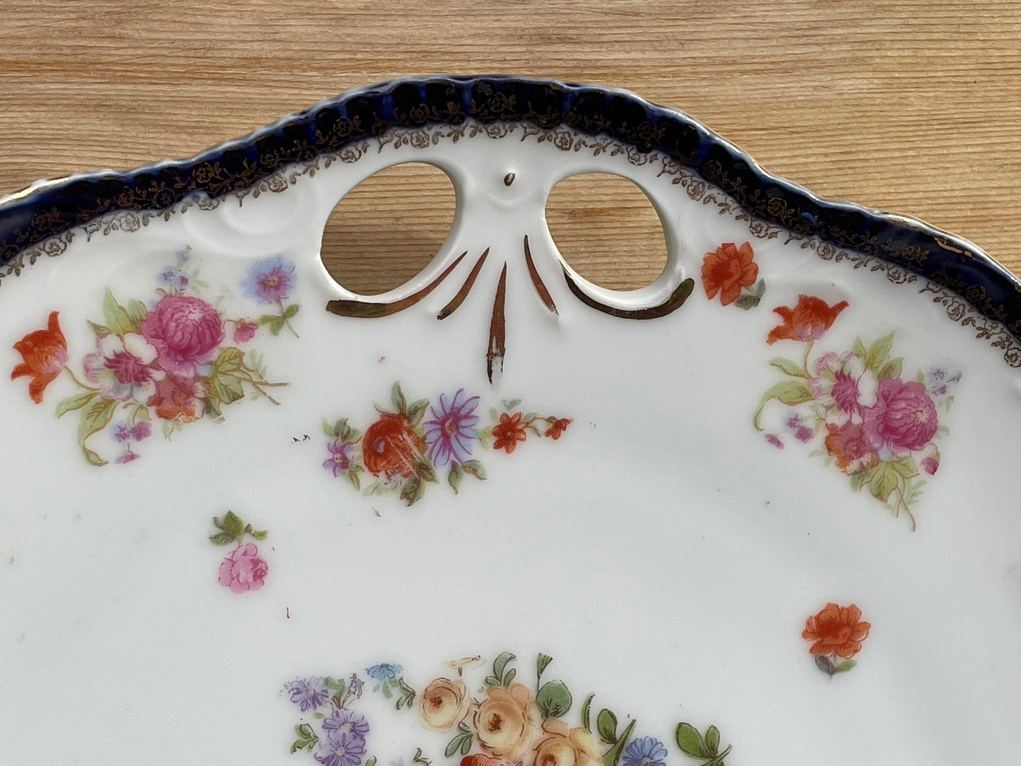 Porcelain gilded pierced dinner flower pattern plate marked 297 to rear 25cm diameter