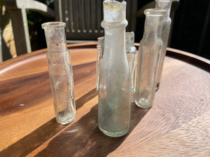 Seven Antique and vintage glass bottles tallest 15cm