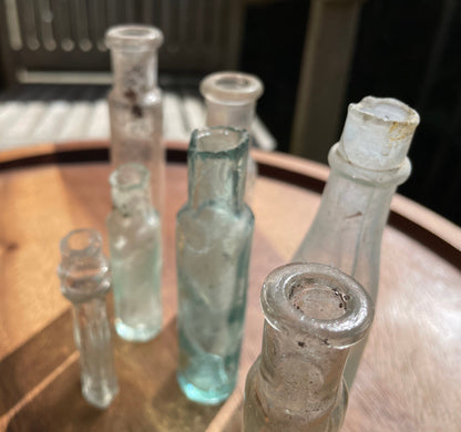 Seven Antique and vintage glass bottles tallest 15cm